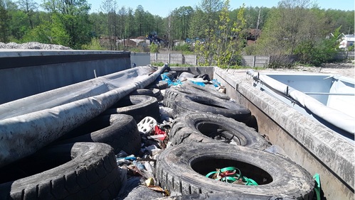 Opony samochodowe i odpady komunalne znajdujące się na naczepie samochodu ciężarowego.